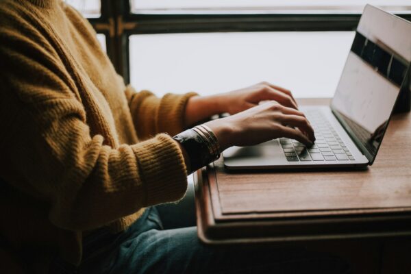 woman typing in the laptop
