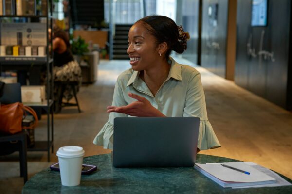 woman sitting at the table with a laptop